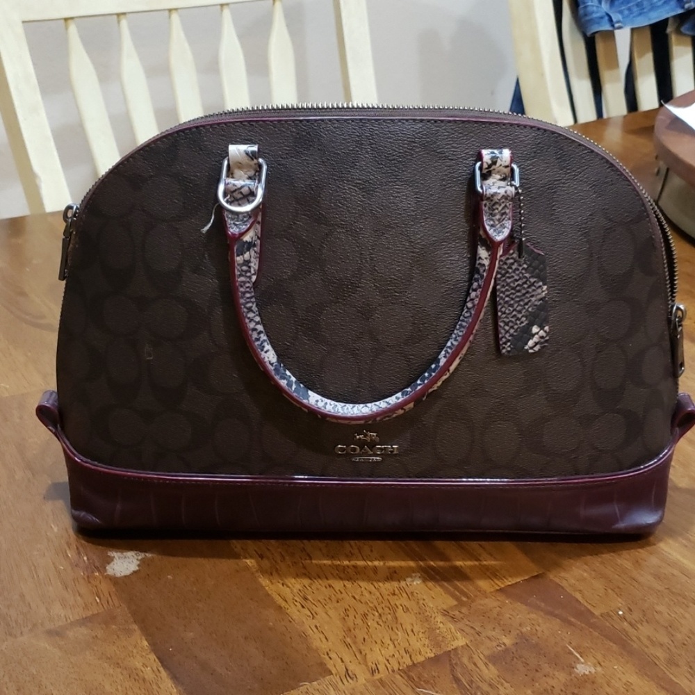 Coach Burgandy and snakeskin like handles..